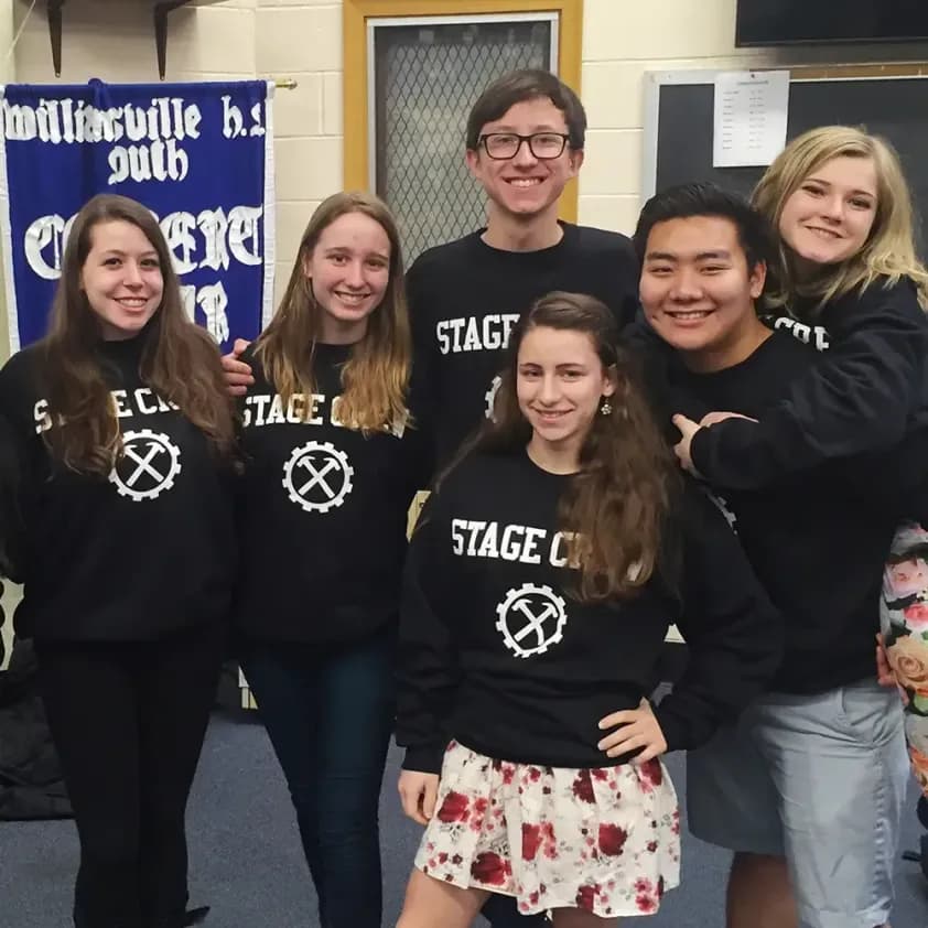 High school stage crew team wearing matching custom black sweatshirts with white printed logos.